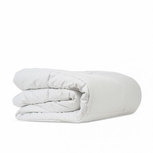 Folded white Camelus camel wool duvet with a quilted cotton shell